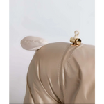 Beige satin-like fabric handbag with plush ear and gold-tone clasp complementing kombinezon dla psa with fur hood