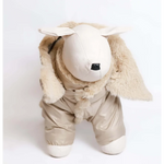 A plush beige lamb figurine wearing bonita kombinezon dla psa with detachable hood faux fur and shiny fabric pants