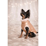 A shiny rose gold quilted kurtka dla psa with white faux fur trim designed for comfort and style for psa