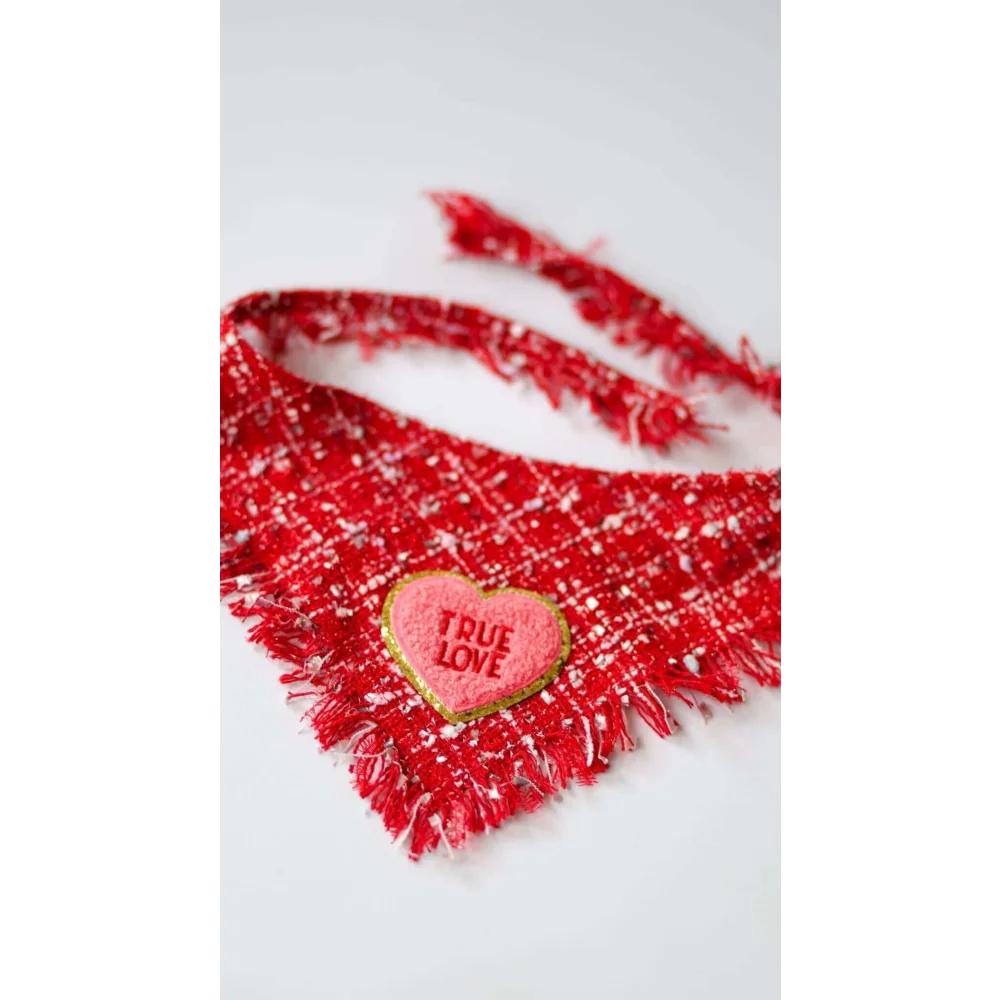 A red tweed chusta true love dog bandana with fringes and a pink heart patch embroidered true love coco