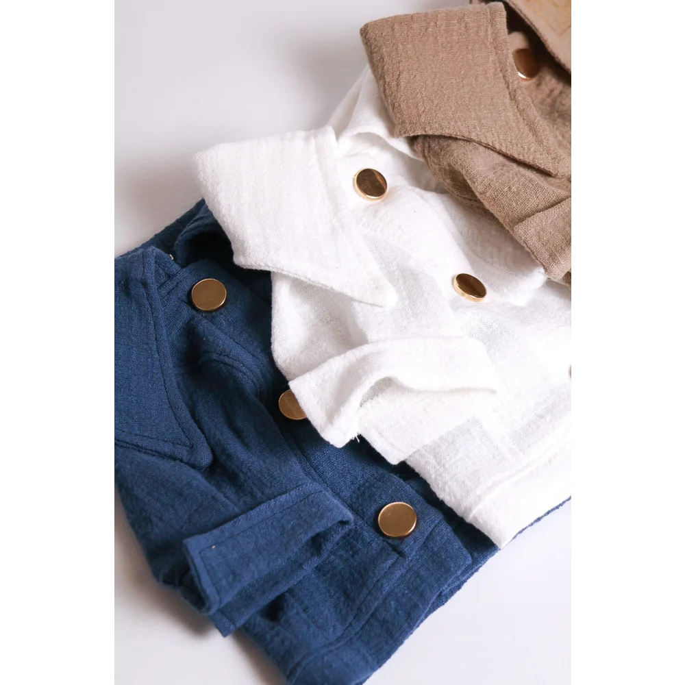 Stacked cotton jackets in navy white and beige with gold-tone buttons designed as cieplejsze dni koszula dla psa