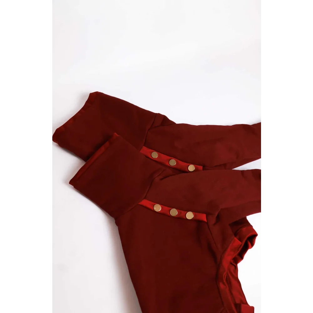 A pair of burgundy high-waisted trousers with gold-toned buttons and ruffled hem shown alongside bluza dla psa z mikropolarem alpejskim