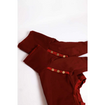 A pair of burgundy high-waisted trousers with gold-toned buttons and ruffled hem shown alongside bluza dla psa z mikropolarem alpejskim