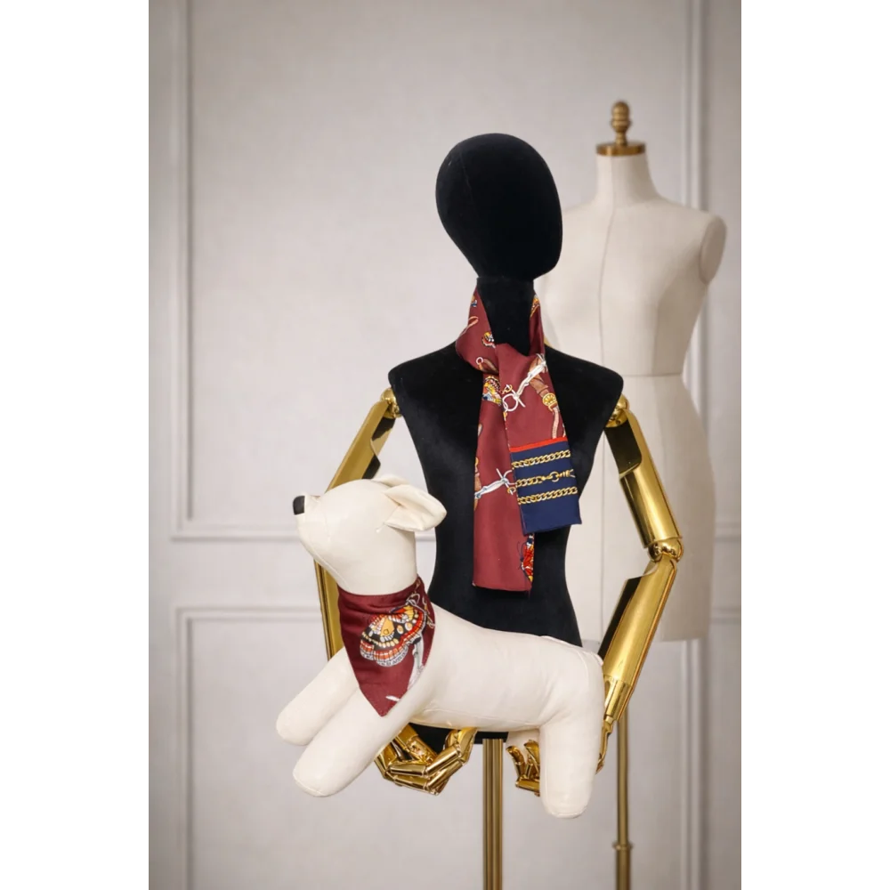 A rich burgundy silk riviera set scarf with gold and navy patterns featuring horses and chains for psa and humans