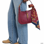 A burgundy ostrich-embossed leather handbag with gold hardware and a matching riviera set jedwabne apaszki dla psa