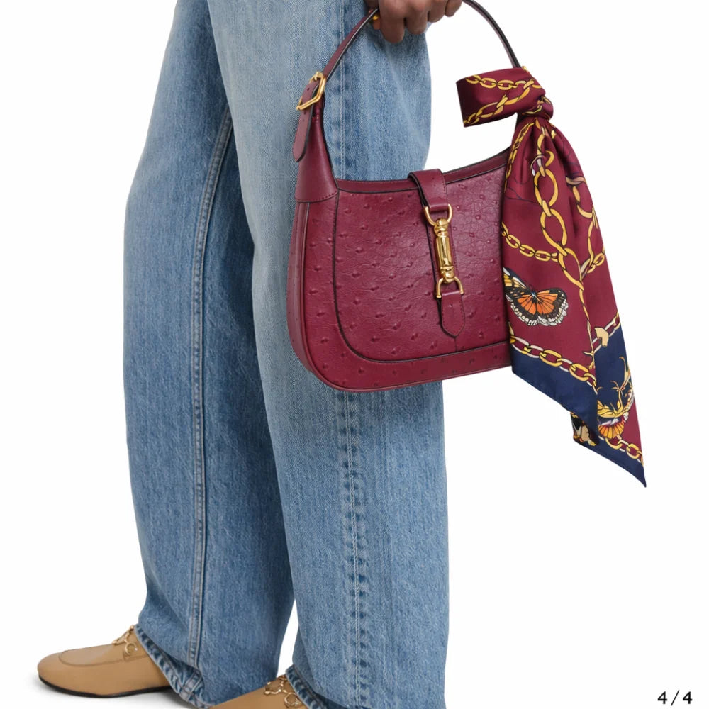 A burgundy ostrich-embossed leather handbag with gold hardware and a matching riviera set jedwabne apaszki dla psa