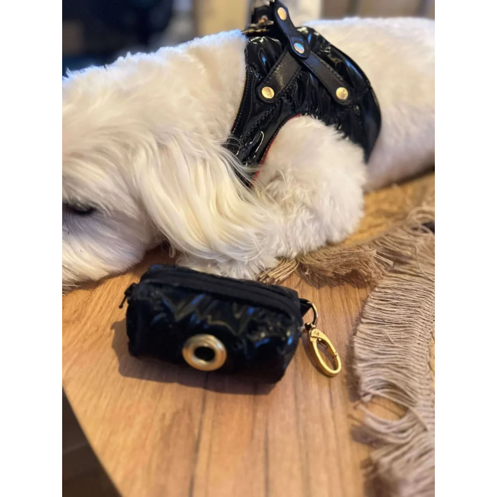 Black glossy dog waste bag holder with gold-tone metal clasp and key ring for premium szelki dla psa accessories
