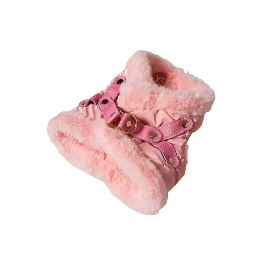 Pink faux fur-lined winter boot with pink leather straps and gold-tone hardware for warmth and style