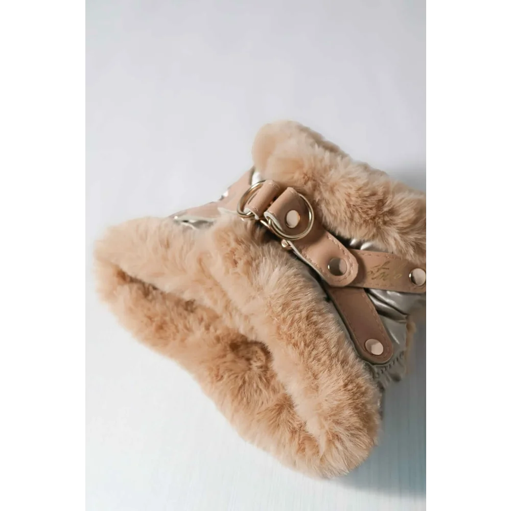 Beige faux fur-lined winter boot with tan leather straps and metallic buckles designed for obwód szyi dla psa use