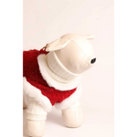White plush dog accessory wearing red knitted sweterek z naturalnej wool next to szelki tweedowe z futerkiem