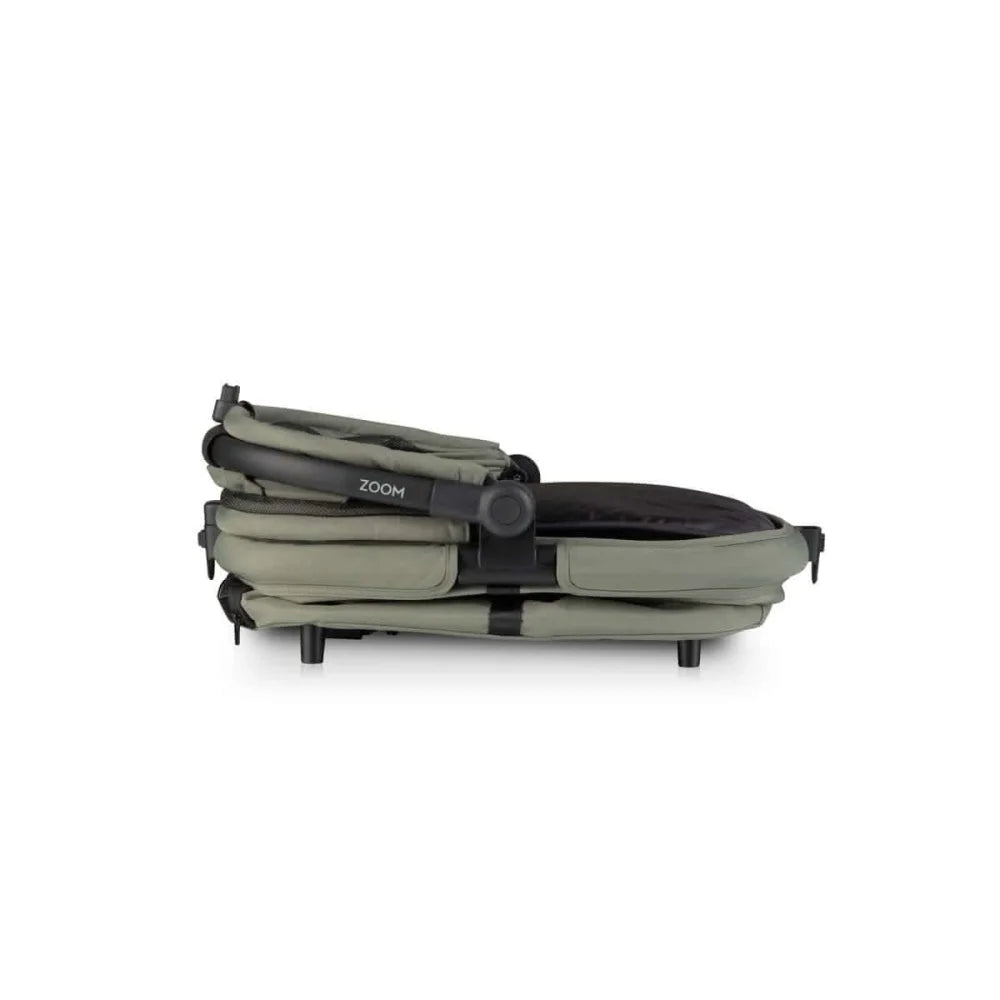 Olive green fabric stroller with black accents and a ’zoom’ branded handle.