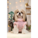 A fluffy shih tzu wearing a pink tweed vest with plush trim in a zestaw 2w1 dla psa made of naturalnej wełny