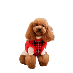 A fluffy brown poodle wearing a zestaw 2w1 dla psa red and black plaid sweterek with adjustable obwód klatki and szyi